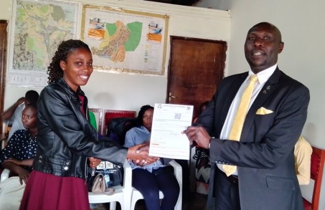 Rushoga Hands over UBOS Appointment letter to one of the Enumerators