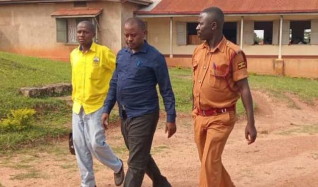Onesmas Twinamasiko being led away by a Prisons Warder after being remanded