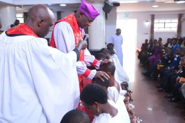 Kaziimba Mugalu confirming Christians in the Anglican Faith