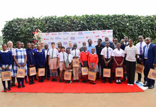 A section of winners pose for a group photo together with teachers and guests