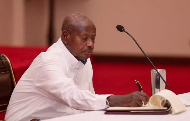 Museveni signing the bill into law