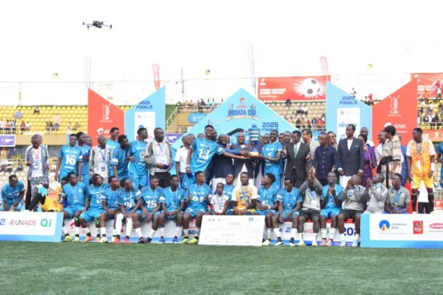 Kabaka Mutebi II hands over the trophy to Buweekula players